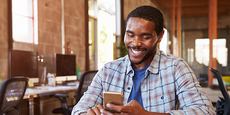 man looking at alerts on mobile phone